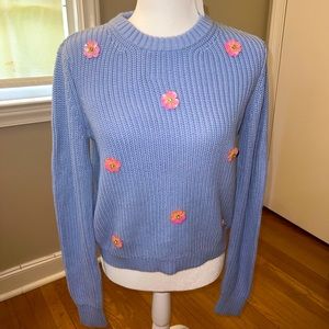 Light blue sweater with pink flower accents